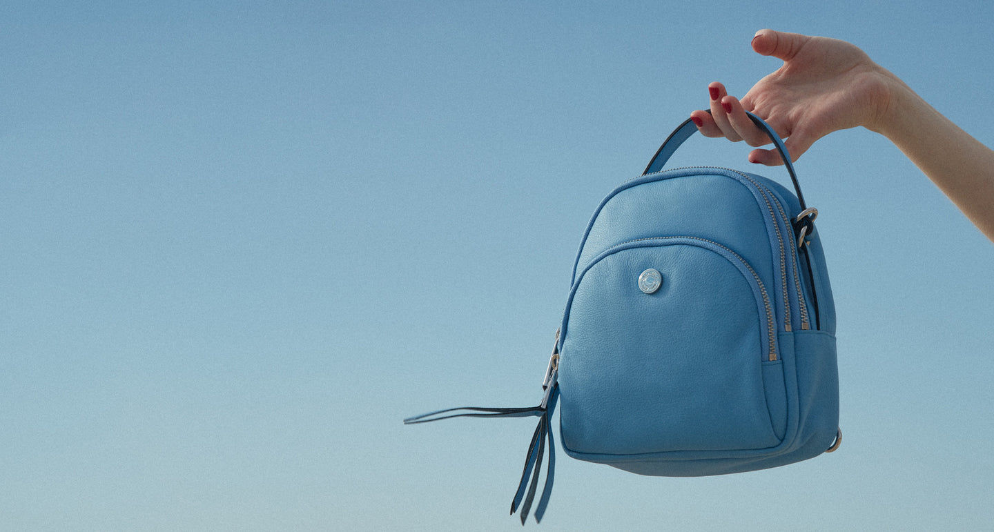 versatile sunrise bag that can be worn in 4 ways: backpack, crossbody, beltbag, top handle